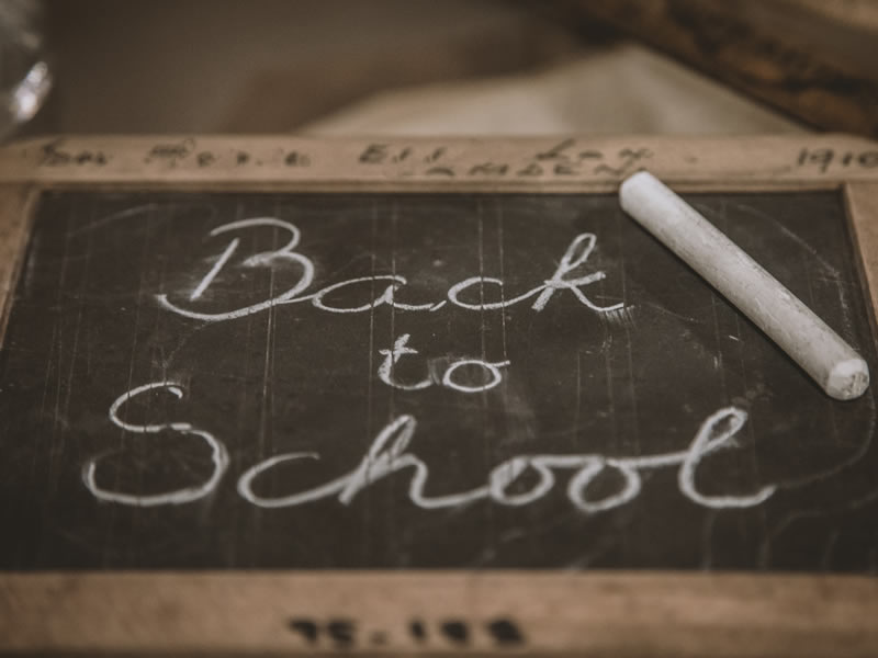 Back to School handwritten on a blackboard. Photo by Deleece Cook on Unsplash.