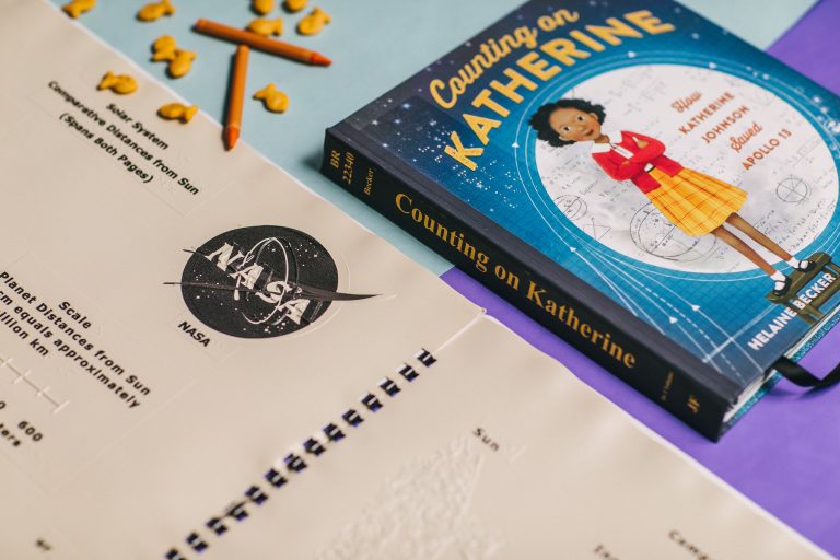 Back to school image with braille page and a book on a table.