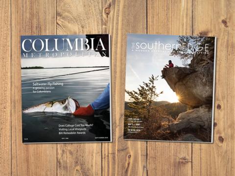A pair of magazines on a wooden table top.